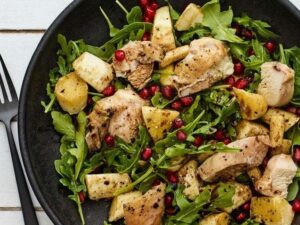 Mixed green salad with ½ chicken breast mixed with 1 tablespoon light mayonnaise, 1 tablespoon of pistachios and ½ cup pomegranate